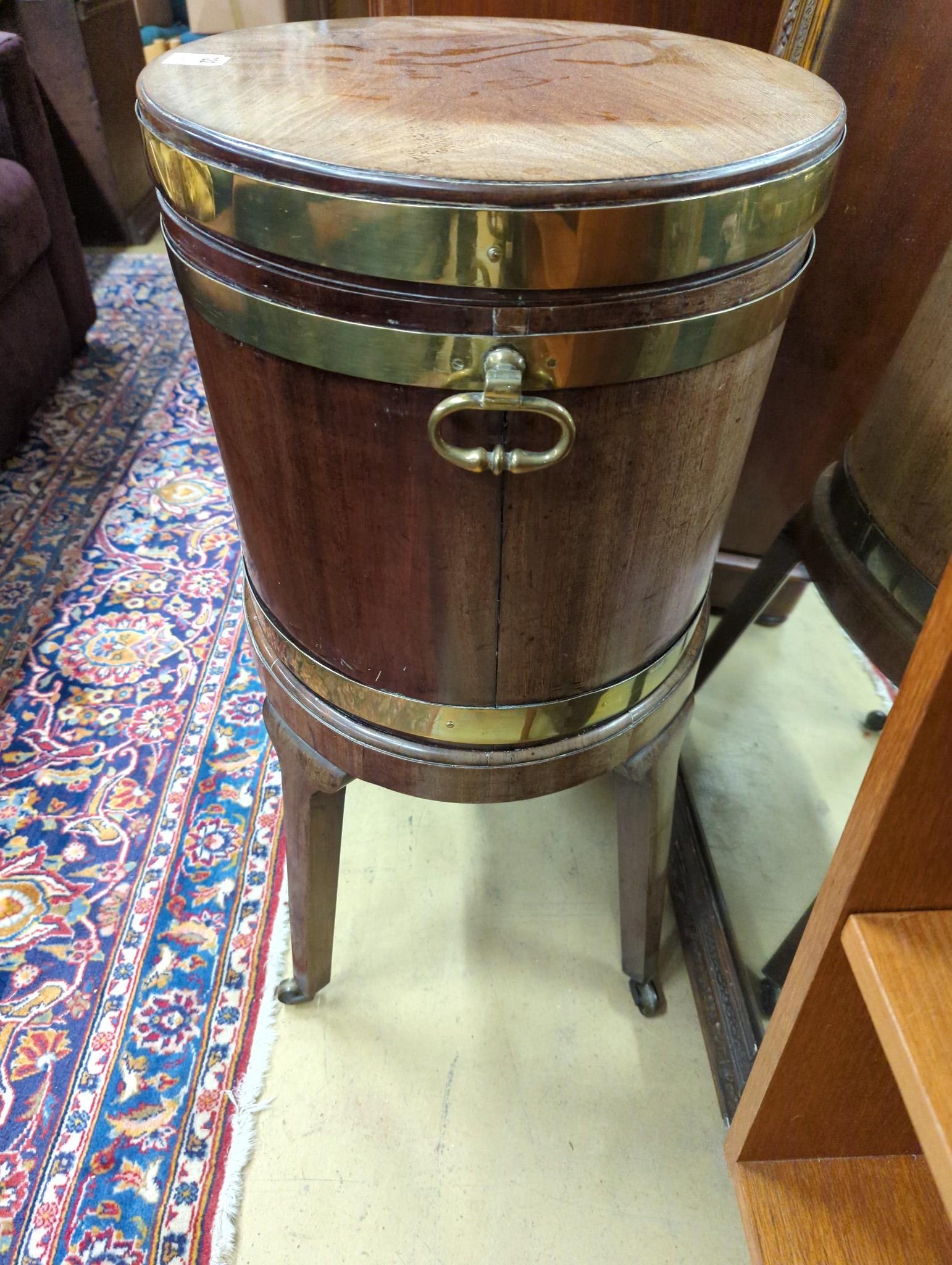 A George III mahogany triple brass bound oval wine cooler on stand, width 56cm, depth 43cm, height 78cm